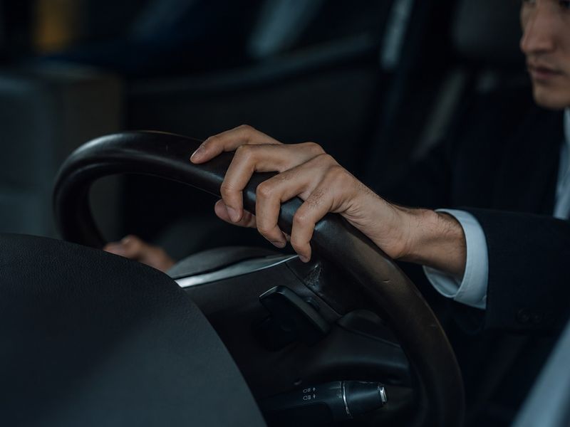 Chauffeur in a suit at the wheel